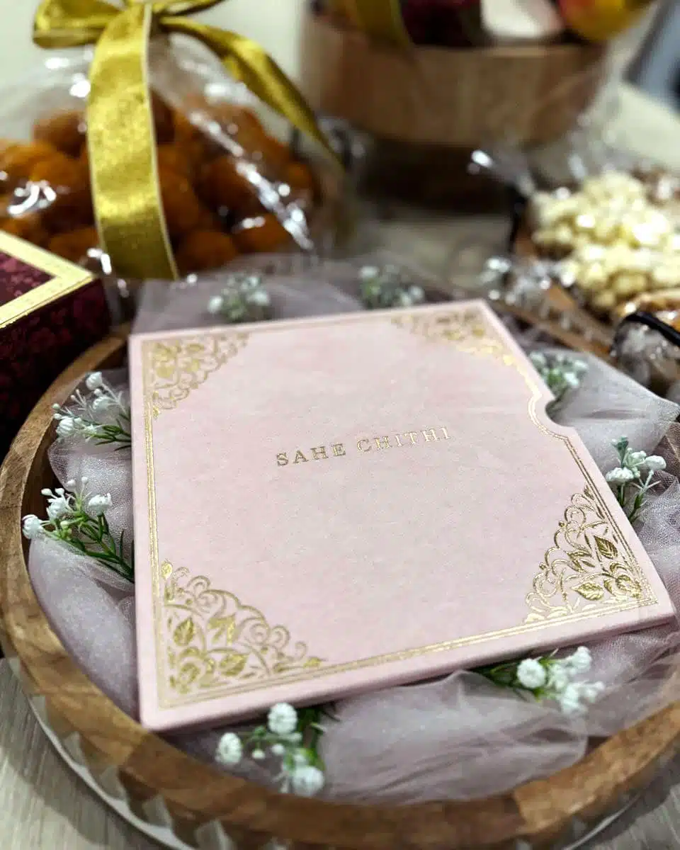 Luxury Square Pink Sahe Chithi in a wooden bowl with mithai